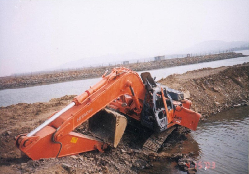 excavator slide into the pond 