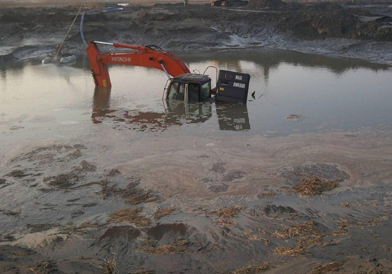 excavator caught in the mud